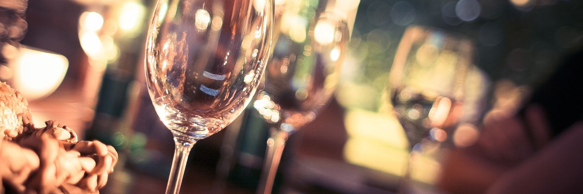Wine glasses in soft focus on a dinner table